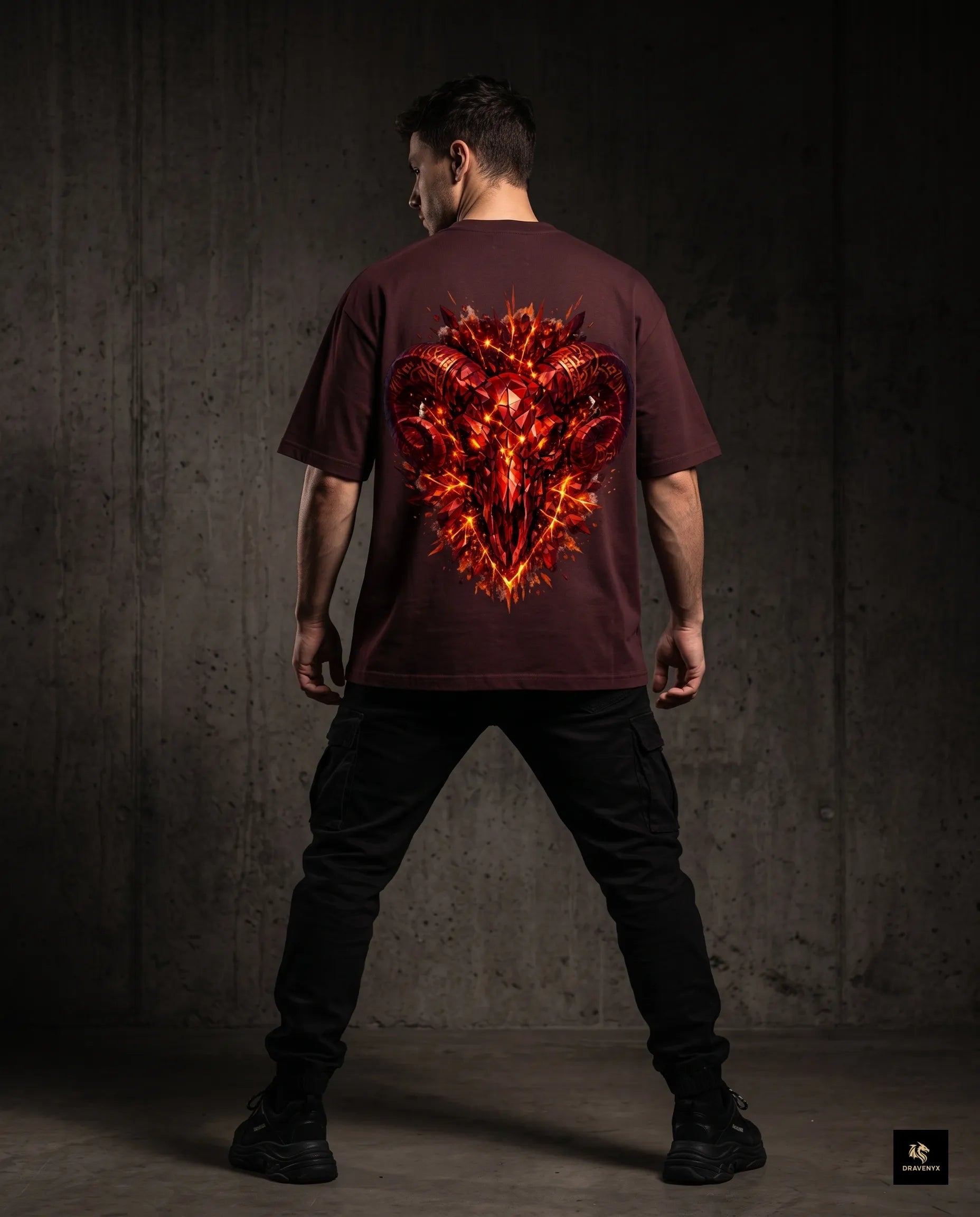 DRAVENYX® Aries Infernal Ram Oversized Tee in Maroon — front view featuring left-chest crystalline Aries wing-mark emblem in molten amber and iron tones — back view showing full DTF print of infernal crystal ram skull with rune-inscribed curling horns and golden ember burst