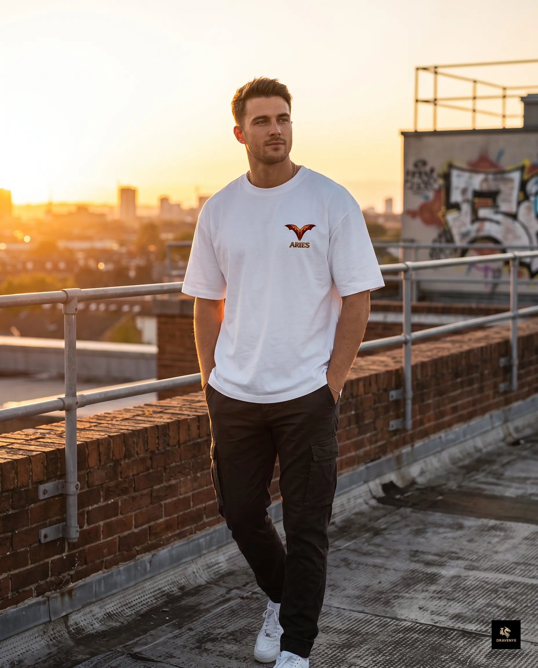 DRAVENYX® Aries Infernal Ram Oversized Tee in White — front view featuring left-chest crystalline Aries wing-mark emblem in molten amber and iron tones — back view showing full DTF print of infernal crystal ram skull with rune-inscribed curling horns and golden ember burst