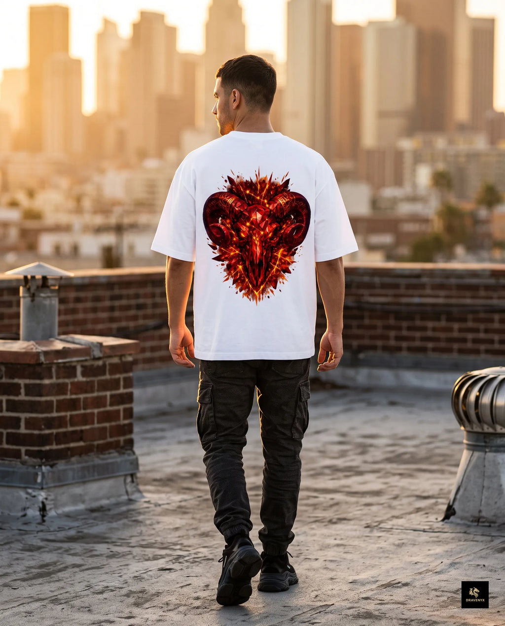 DRAVENYX® Aries Infernal Ram Oversized Tee in White — front view featuring left-chest crystalline Aries wing-mark emblem in molten amber and iron tones — back view showing full DTF print of infernal crystal ram skull with rune-inscribed curling horns and golden ember burst