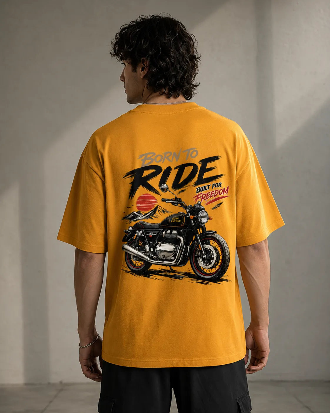 DRAVENYX® Born To Ride oversized tee in Golden Yellow — front view showing left chest moto-badge print and drop-shoulder silhouette — back view with full-panel moto-art graphic and 'Born To Ride / Built For Freedom' DTF print