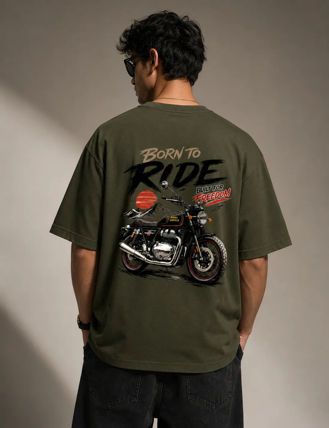 DRAVENYX® Born To Ride oversized tee in Olive Green — front view showing left chest moto-badge print and drop-shoulder silhouette — back view with full-panel moto-art graphic and 'Born To Ride / Built For Freedom' DTF print