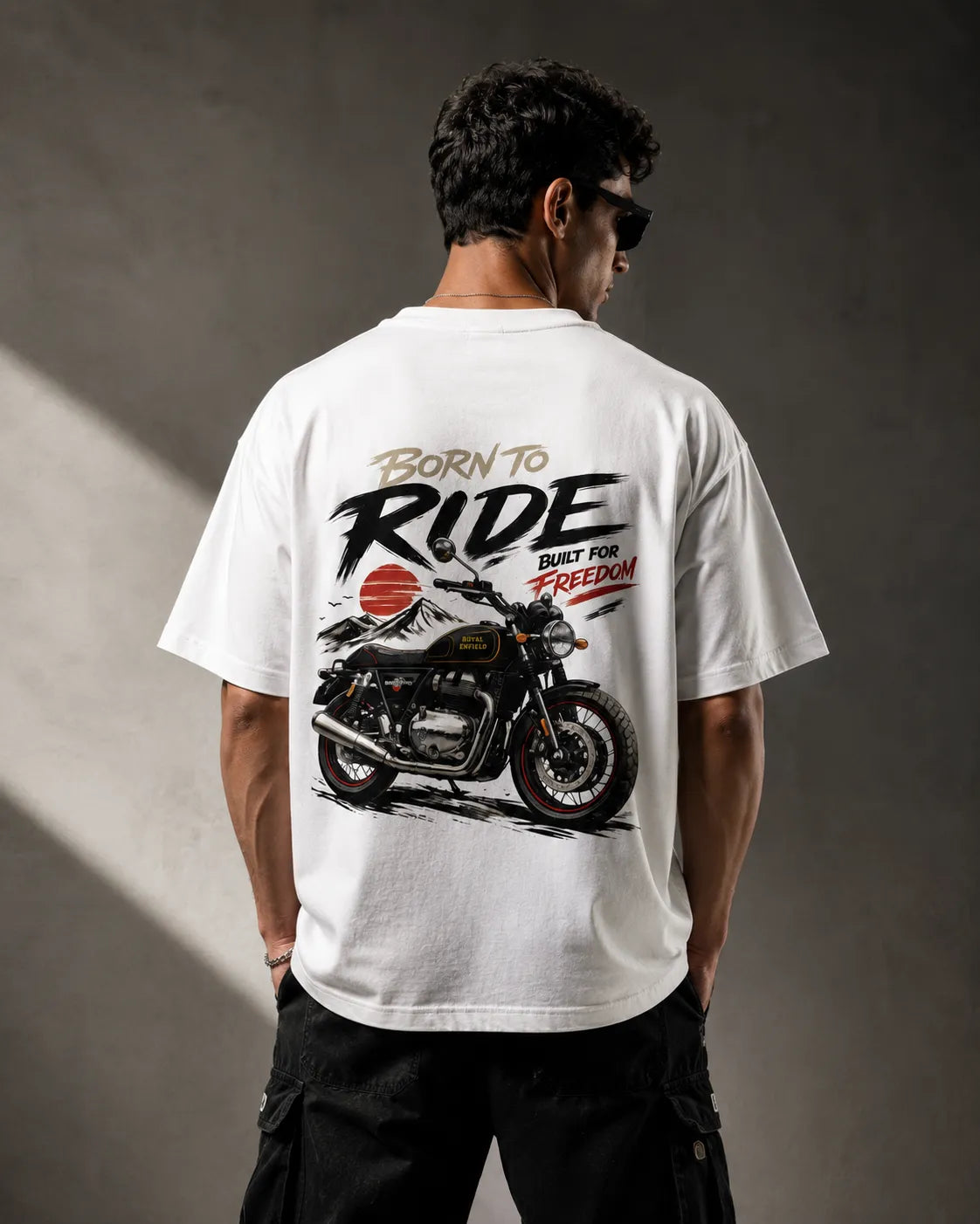 DRAVENYX® Born To Ride oversized tee in White — front view showing left chest moto-badge print and drop-shoulder silhouette — back view with full-panel moto-art graphic and 'Born To Ride / Built For Freedom' DTF print